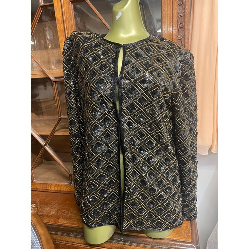 776 - A sequin jacket in black & gold 'After Six' by Ronald Joyce (London) Ltd, metal hock & eye fastening... 