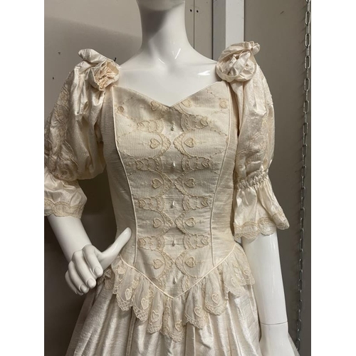 777 - A vintage style wedding dress in a cream/gold colour with lace/embroidery detailing