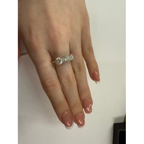 50 - An 18ct three stone diamond ring, size Q. 5.41 grams.