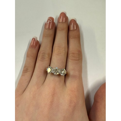 50 - An 18ct three stone diamond ring, size Q. 5.41 grams.