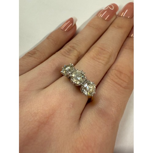 50 - An 18ct three stone diamond ring, size Q. 5.41 grams.