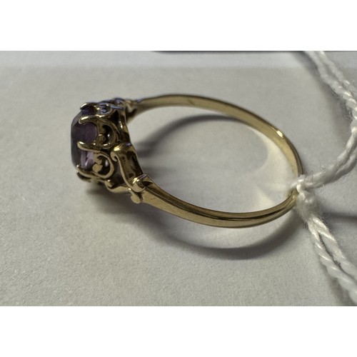 77 - A 9ct gold amethyst ring with fancy shoulders, size P, 1.4 grams.