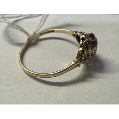 77 - A 9ct gold amethyst ring with fancy shoulders, size P, 1.4 grams.