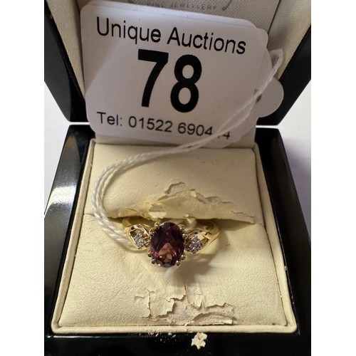 78 - A 9ct gold ring set red stone with diamond shoulders, size R, 2.3 grams.