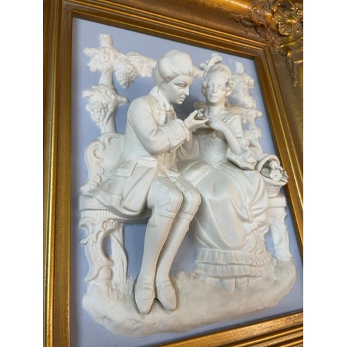 277 - A superb gilt framed bisque porcelain plaque featuring a romantic couple.