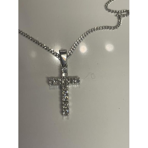 1 - An 18ct white gold and diamond cross on an 18ct gold chain. 4.37 grams