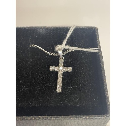 1 - An 18ct white gold and diamond cross on an 18ct gold chain. 4.37 grams