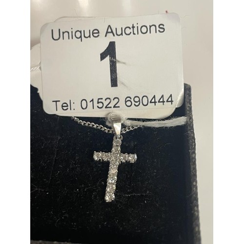 1 - An 18ct white gold and diamond cross on an 18ct gold chain. 4.37 grams