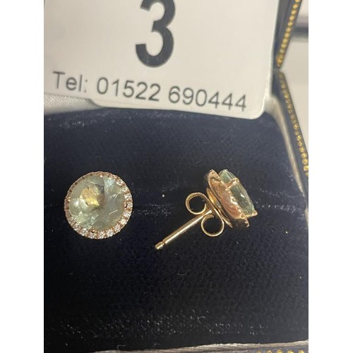 3 - A pair of 18ct gold and aquamarine earrings. 2.35 grams