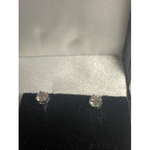 6 - A pair of 9ct gold 20pt diamond studs.