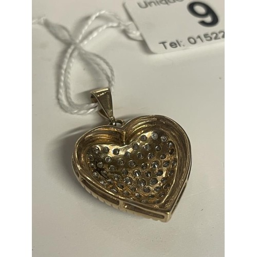 9 - An approximately 3 carat diamond heart set in two tone gold, 7.19 grams.