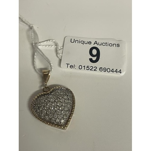 9 - An approximately 3 carat diamond heart set in two tone gold, 7.19 grams.