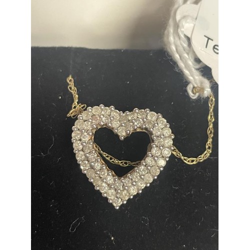 11 - A yellow gold and diamond heart on a 9ct gold chain, 4 grams.