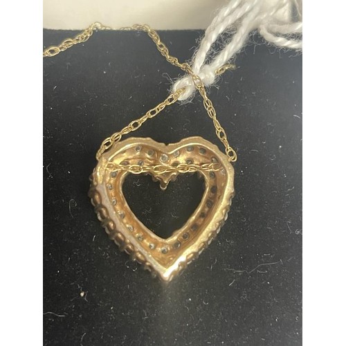 11 - A yellow gold and diamond heart on a 9ct gold chain, 4 grams.