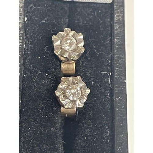 16 - A pair of white gold diamond stud earrings, 1.28 grams.