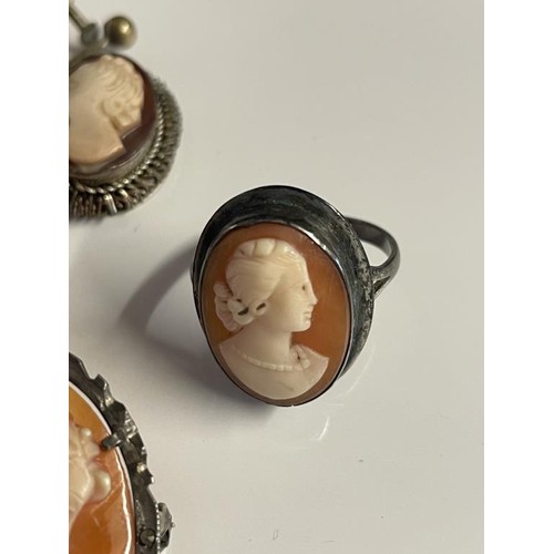 21 - Two shell cameo brooches in silver mounts, a pair of white metal cameo earrings and a cameo ring.