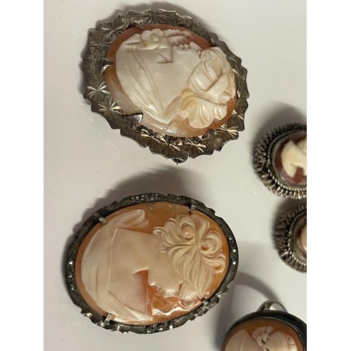 21 - Two shell cameo brooches in silver mounts, a pair of white metal cameo earrings and a cameo ring.