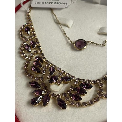 22 - A good quality necklace and pendant set amethyst coloured stones.