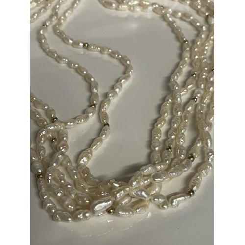 24 - A superb three strand natural pearl necklace with 14k gold clasp.