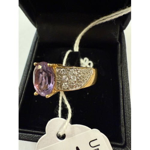 70J - A gold ring set with amethyst tiny clear stones