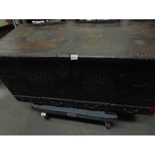 600L - A large old trunk with metal stud decoration.