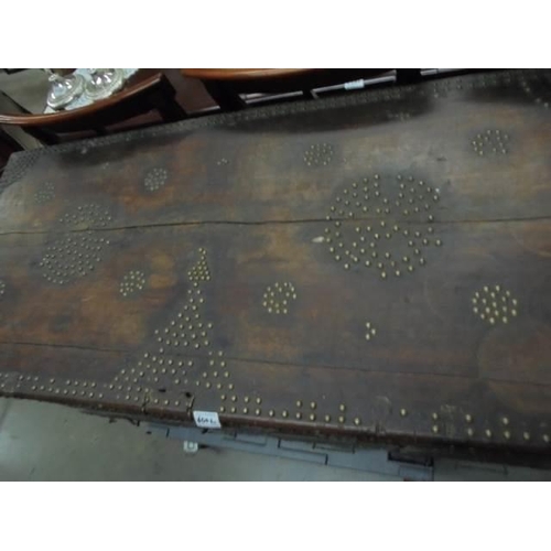 600L - A large old trunk with metal stud decoration.