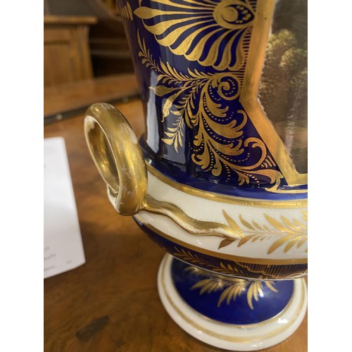 677 - A Derby cobalt ground vase of campana form with gilt snake handles, painted with a traveller in a wo... 