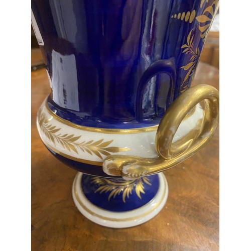 677 - A Derby cobalt ground vase of campana form with gilt snake handles, painted with a traveller in a wo... 