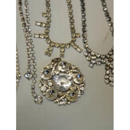 502 - Eight pieces of diamonte' jewellery including cross pendant.