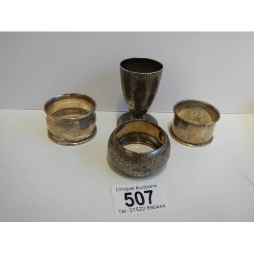 507 - Three hall marked silver napkin rings and a hall marked silver egg cup.