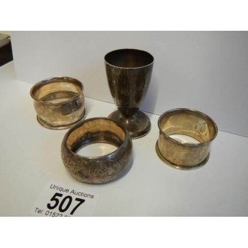 507 - Three hall marked silver napkin rings and a hall marked silver egg cup.