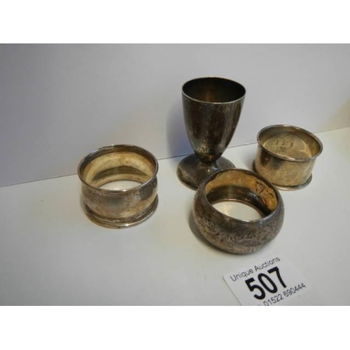 507 - Three hall marked silver napkin rings and a hall marked silver egg cup.