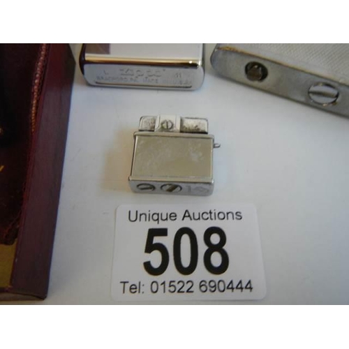 508 - Four vintage cigarette lighters including Zippo, Ronson and a miniature example.