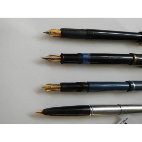 514 - Four vintage fountain pens.