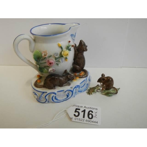 516 - A porcelain cream jug surmounted mice and another mouse figure.