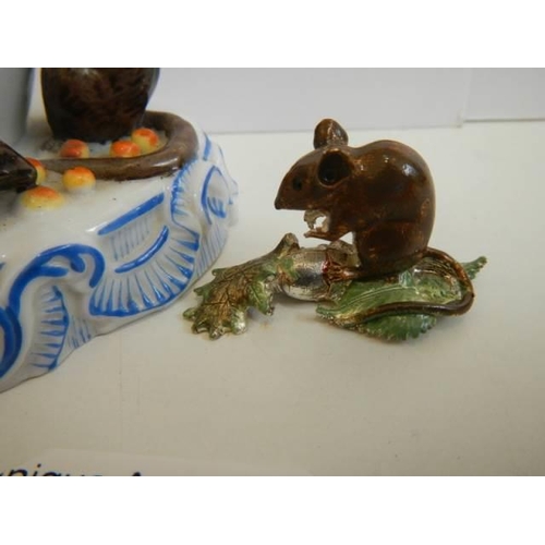 516 - A porcelain cream jug surmounted mice and another mouse figure.