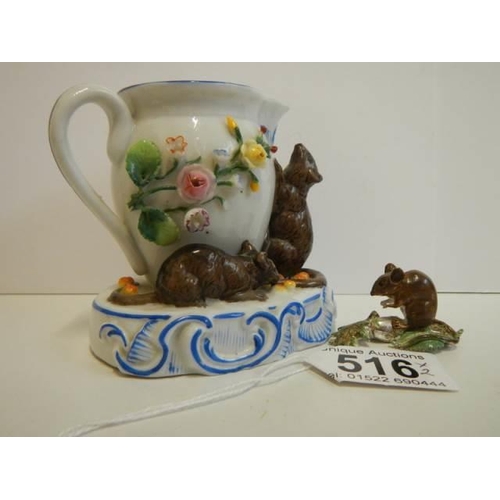 516 - A porcelain cream jug surmounted mice and another mouse figure.