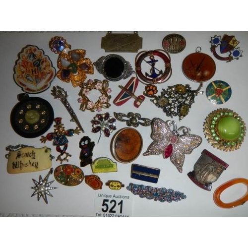 521 - In excess of thirty assorted brooches, badges etc.,