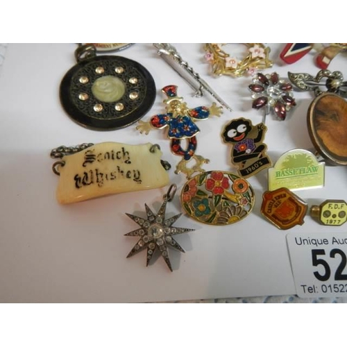 521 - In excess of thirty assorted brooches, badges etc.,