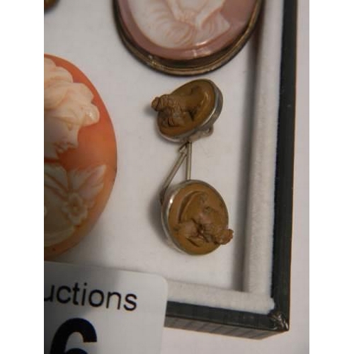 526 - Two cameo brooches, two un-mounted cameos and one other item.