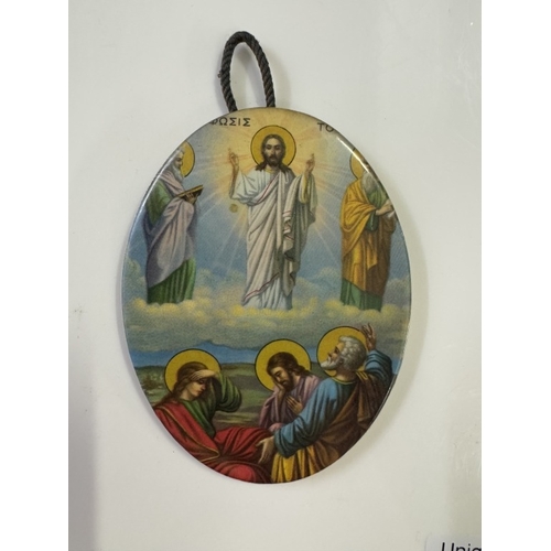 543 - An un-marked silver framed religious print and a metal oval miniature religious plaque.