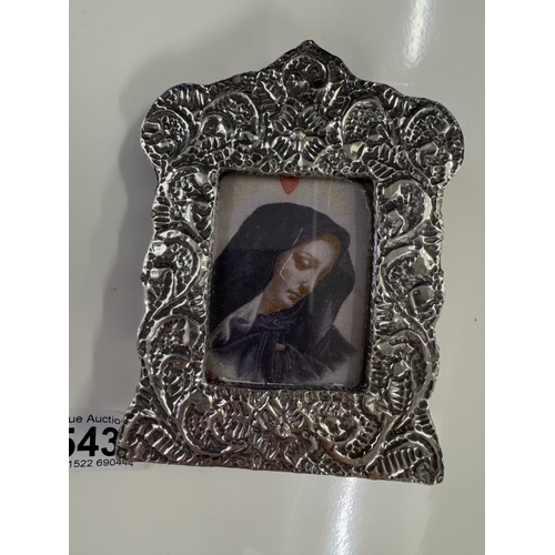 543 - An un-marked silver framed religious print and a metal oval miniature religious plaque.