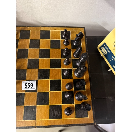 559 - A vintage wooden chess set with folding board box