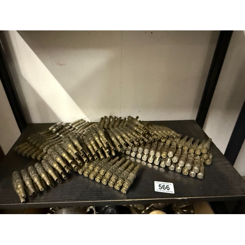 566 - A large lot of Spent shell cases on belts