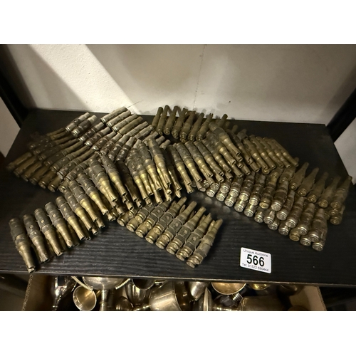 566 - A large lot of Spent shell cases on belts