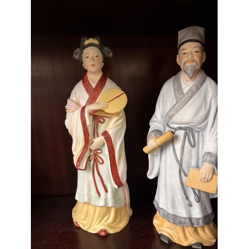 587 - A pair of unglazed ceramic oriental figures