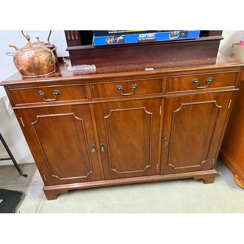 590 - A dark wood stained 3 drawer 3 door wall unit