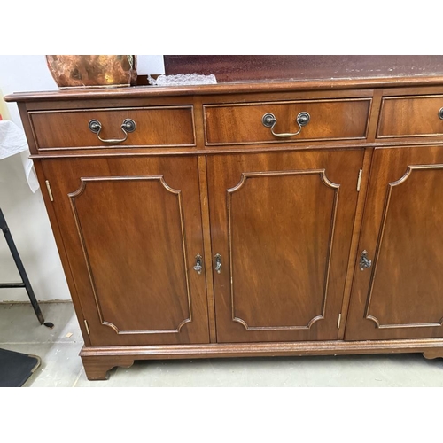 590 - A dark wood stained 3 drawer 3 door wall unit