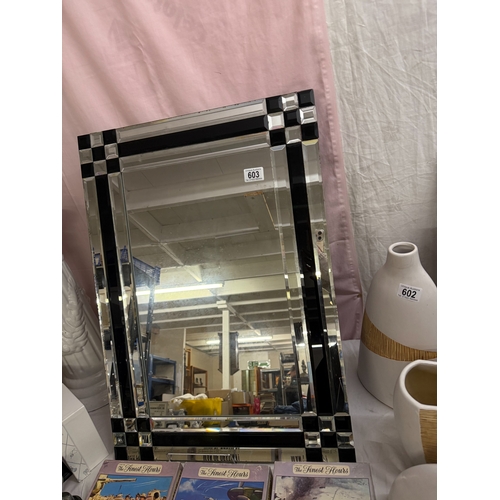 603 - An art deco bevel edge mirror with mosaic glass frame