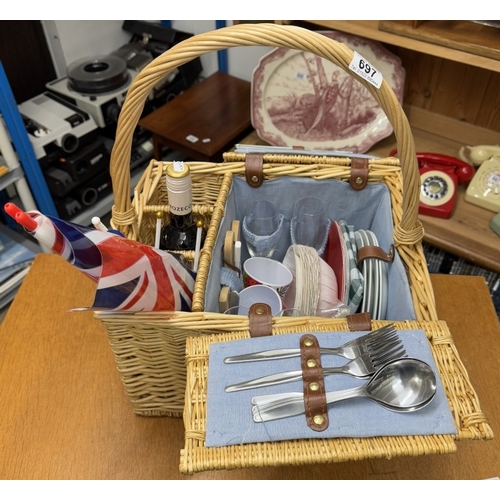 697 - A picnic hamper with contents & a bottle of alcohol free merlot wine